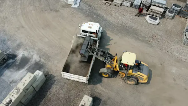 Forklift operator handling goods at construction site